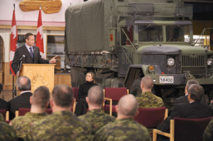 Former Defence Minister Peter MacKay with one of the old-timers in the Army's fleet of trucks. 