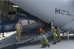 Members from Canadian Forces Base Trenton load three CH-146 Griffon helicopters into a CC-177 Globemaster aircraft at CFB Trenton, Ontario, May 4, 2016.