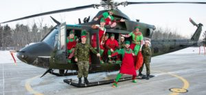Elves from 400 Tactical Helicopter Squadron, Canadian Forces Base Borden, load a CH-146 Griffon helicopter with toys bound for the Hospital for Sick Children as part of Operation Ho-Ho-Ho on 14 December, 2016. L-R: Aviator Wilson, Captain Pollard, Odinairy Seaman Anderson, Corporal Hamel, Aviator Rittershofer, Master Corporal Merner, Major Laycock, Aviator Rodrigues, Corporal MacIlroy, Captain Hill. (Image taken by Corporal Lindsay Neifer)