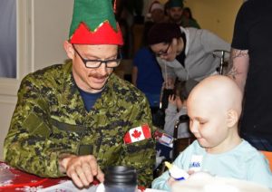 Corporal Lorne McDermot and a child at Sick Kids Hospital in Toronto make crafts together during Operation Ho Ho Ho on December 14, 2016. PHOTO: © Steve Bigg, Locked On Photography