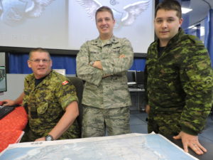 In anticipation of Santa’s travels on Christmas Eve, members of 21 Aerospace Control & Warning Squadron’s Delta Flight, from 22 Wing North Bay, Ontario, review Santa’s possible course into Canadian air space using a NORAD radar coverage chart. This year’s “Santa Trackers” include Captain Jim Mersereau, mission crew commander (left), Lieutenant-Colonel (USAF) Michael Harmon, commander of Detachment 2, First Air Force (centre), and Master Corporal Christian Turcotte, identification supervisor.. PHOTO: Master Corporal Allan Silk