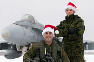 Captain Frédéric Létourneau (kneeling) from 425 Tactical Fighter Squadron at 3 Wing Bagotville, Quebec, is one of the pilots who will escort Santa over North America in 2016. Corporal Steeven Cantin is his crew chief. PHOTO: Corporal Jean-Roch Chabot, 