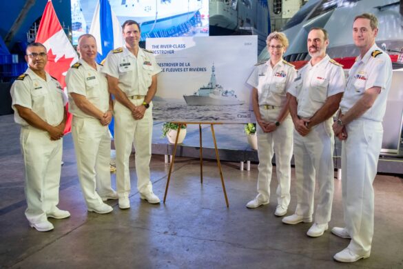 RCN Leadership stand on either side of the poster which shows the rendering of the new River-Class Destroyer.