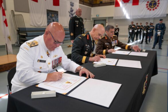 Chief of Defence Staff General Eyre (centre) with outgoing Commander Canadian Joint Operations Command Vice-Admiral Auchterlonie (left), and incoming Commander Canadian Joint Operations Command Lieutenant-General Boivin (right), official signing of scrolls at His Majesty's Canadian Ship Carleton in Ottawa, Ontario on July 8, 2024. Photo Credit: Aviator Douglas Hamilton, Canadian Forces Support Group, (Ottawa-Gatineau)