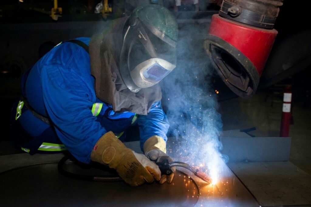 Brad Bishop welding. Image source: https://shipsforcanada.ca/our-stories/future-arctic-and-offshore-patrol-ships-for-canadian-coast-guard-officially-named-ccgs-donjek-glacier-and-ccgs-sermilik-glacier