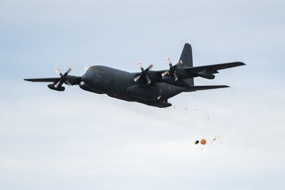 A CC-130 Hercules dispatches a survival raft during training over Lake Winnipeg in Gimli, Manitoba on 25 July 2022. Please Credit: Corporal Eric Greico, Canadian Armed Forces Photo.