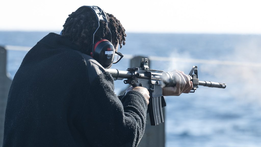 A Royal Canadian Navy Boatswain onboard HMCS CHARLOTTETOWN firing the Colt Canada C8 Rifle during a force protection practice shoot while sailing for Operation HORIZON on 2 February 2026. Photo by: MS Alexandre Heagle Canadian Armed Forces Imagery Technician.