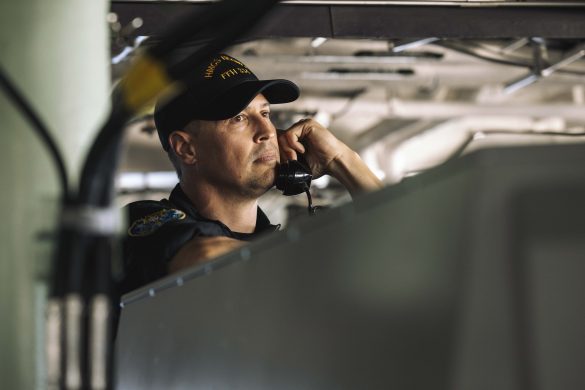Lieutenant Commander MacDonald, Executive Officer of His Majesty's Canadian Ship Regina maintains communications with the ships company during the departure of Canadian Forces Base Esquimalt as part of Operation LATITUDE on 13 August, 2025. Photo by MCpl William Gosse, Canadian Armed Forces.