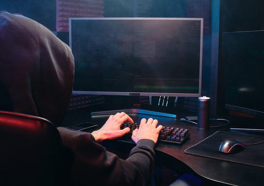 Cyber security is no longer optional for companies operating in Canada’s defence ecosystem. Image source: https://www.pexels.com/photo/person-in-black-hoodie-using-a-computer-6963061/